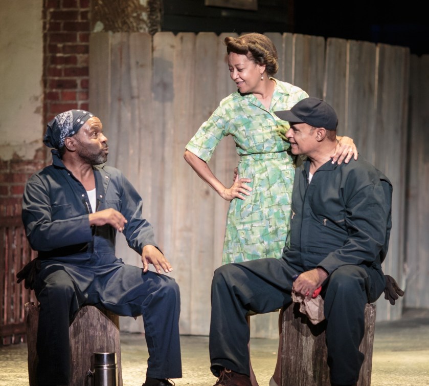 Troy Maxson (Mujahid Abdul-Rashid, right) shares a conversation with co-worker Bono (Victor Little) and wife Rose (Rita Gregory) in an early scene from Fences. (photos by Jason Allen)